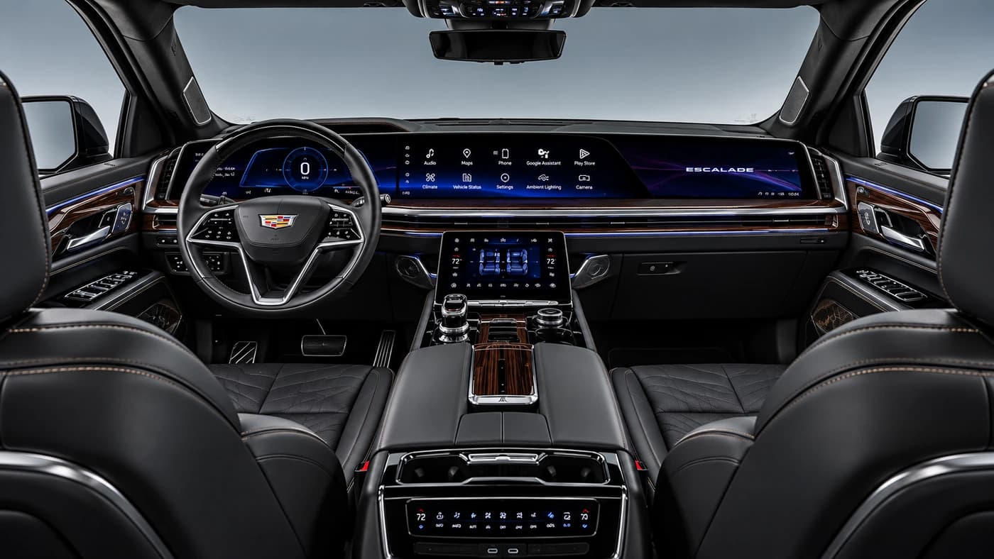 Cadillac Escalade interior from the front: black leather seats, wood trim, digital screens and ambient lighting.