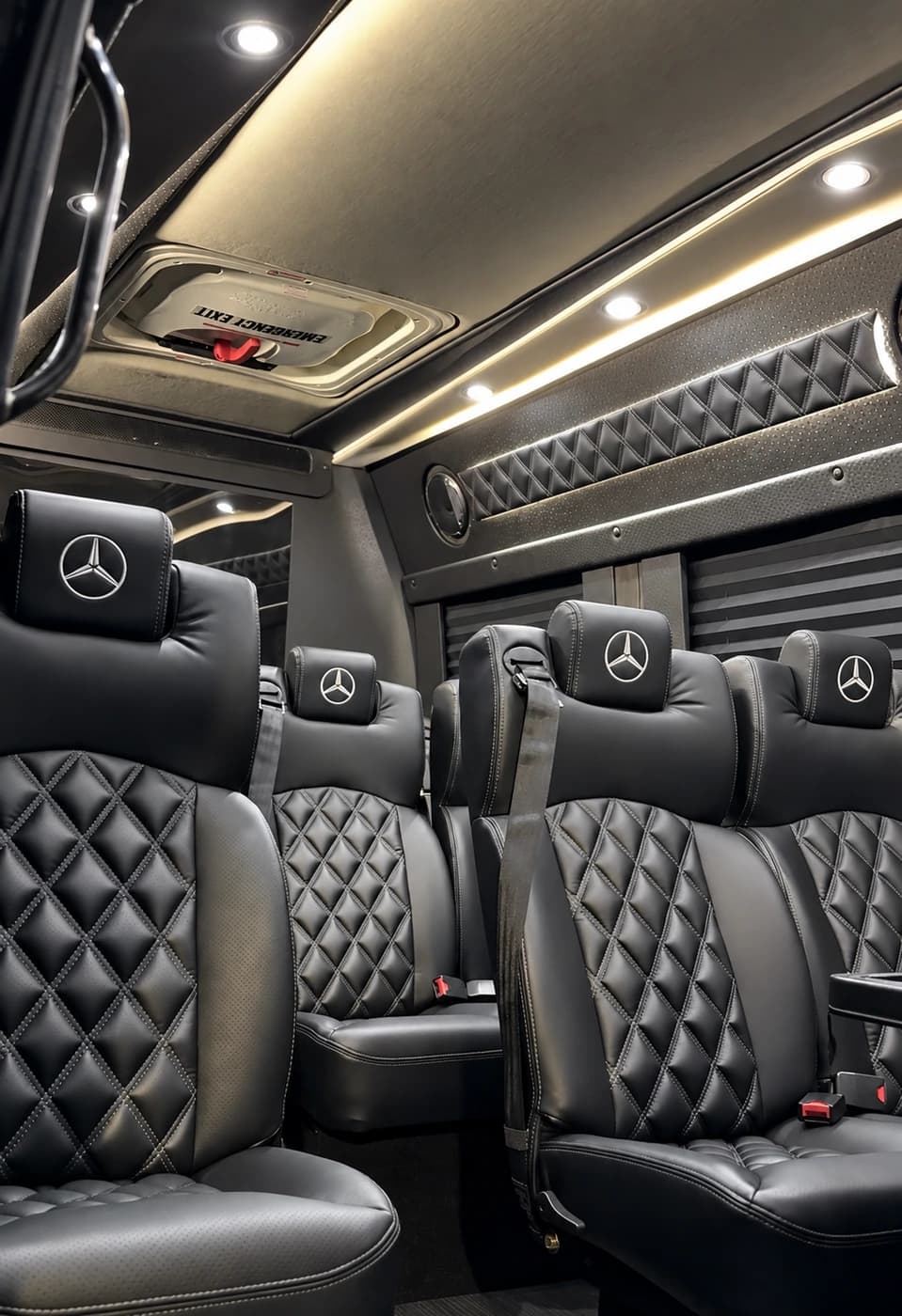 Mercedes-Benz Executive Sprinter cabin with quilted black leather seats and ambient ceiling lighting.